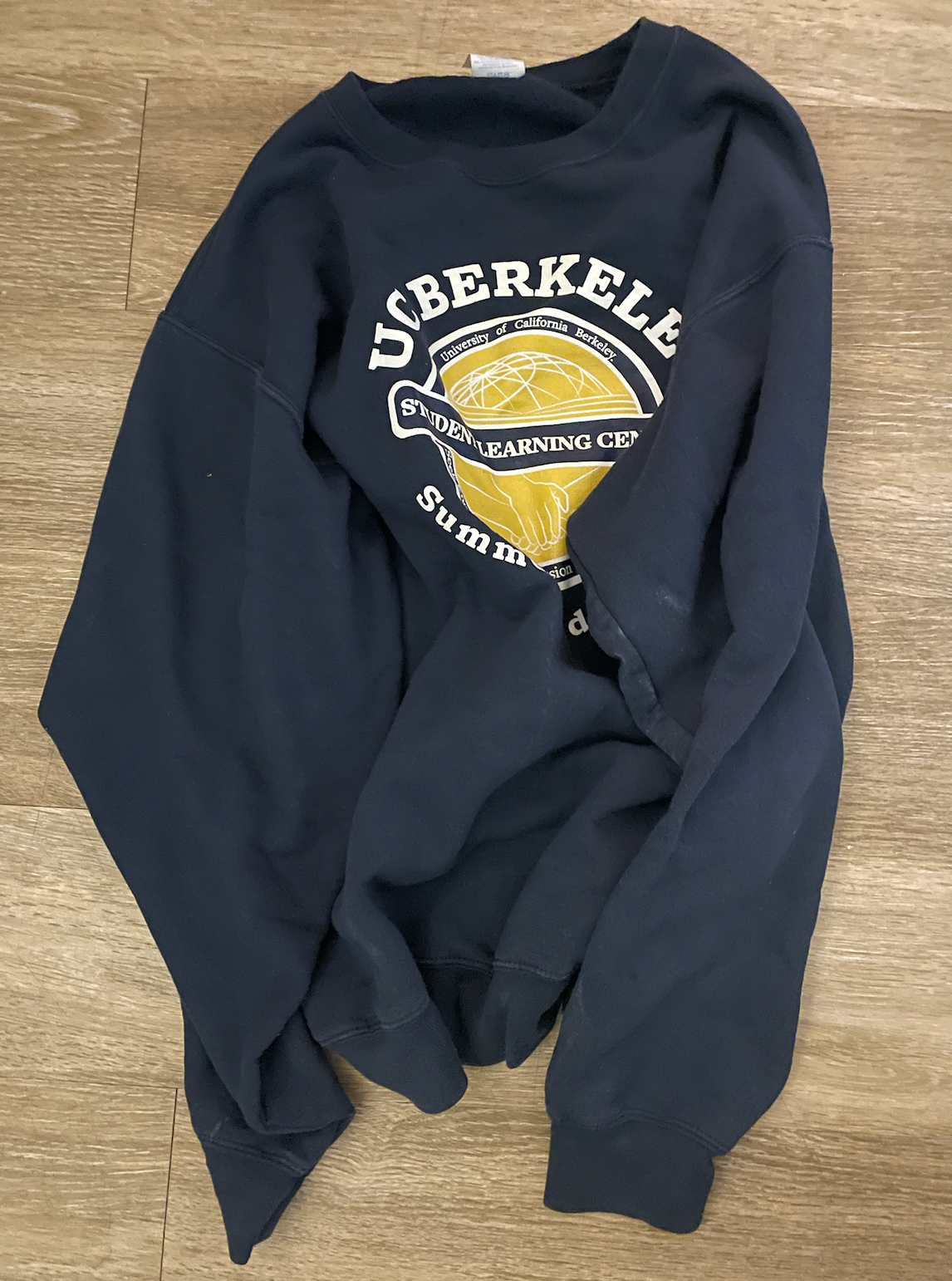 A dark blue sweatshirt. On the sweatshirt is a Berkeley Student Learning Center logo