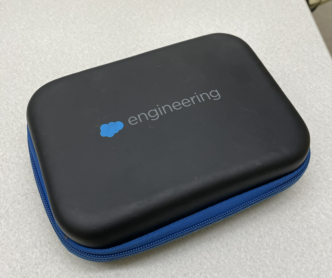 A black pencil case with a blue zipper and a logo that says "engineering" in lowercase letters with a blue cloud logo to the left of the text.